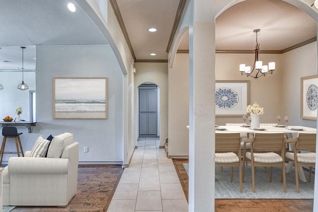 3024 Wakefield Rd, Edmond, OK 73034 - dining space featuring arched walkways, a chandelier, crown molding, recessed lighting, and wood finished floors