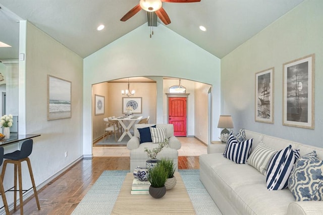 3024 Wakefield Rd, Edmond, OK 73034 - living area featuring arched walkways, wood finished floors, vaulted ceiling, ceiling fan, and a chandelier