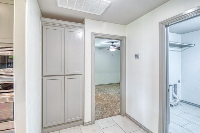3024 Wakefield Rd, Edmond, OK 73034 - hall with light tile patterned floors and baseboards