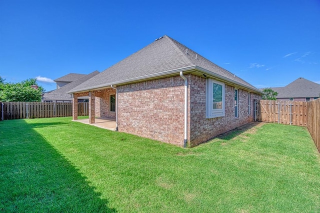 3024 Wakefield Rd, Edmond, OK 73034 - back of property featuring brick siding, a patio area, a fenced backyard, and a shingled roof