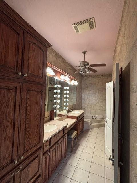 1608 Bentwater Dr, Kingfisher, OK 73750 - full bathroom featuring tile patterned floors, a bath, two vanities, and ceiling fan