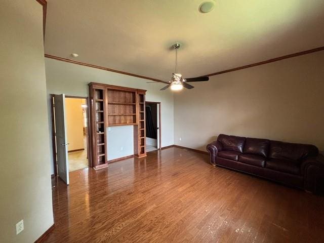 1608 Bentwater Dr, Kingfisher, OK 73750 - unfurnished living room with ceiling fan, wood finished floors, and ornamental molding