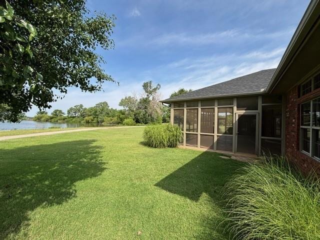 1608 Bentwater Dr, Kingfisher, OK 73750 - view of grassy yard with a sunroom and a water view