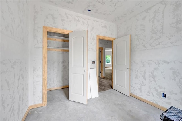 2807 N Lyon Dr, Oklahoma City, OK 73107 - unfurnished bedroom with baseboards and unfinished concrete flooring