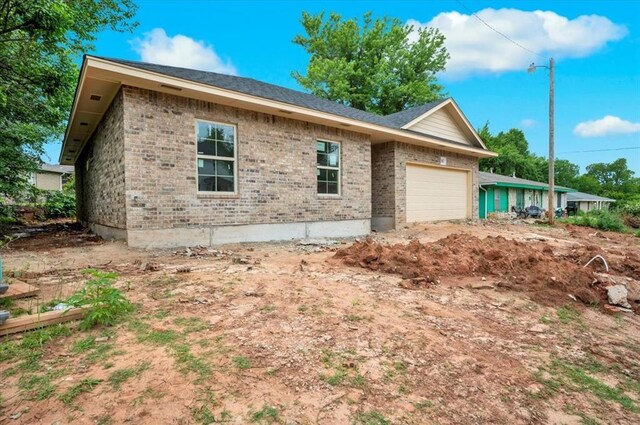 2807 N Lyon Dr, Oklahoma City, OK 73107 - view of side of property with an attached garage and brick siding