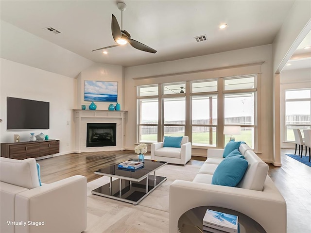 8525 Maple Creek Rd, Arcadia, OK 73007 - living area featuring ceiling fan, healthy amount of natural light, a fireplace, vaulted ceiling, and light wood-type flooring