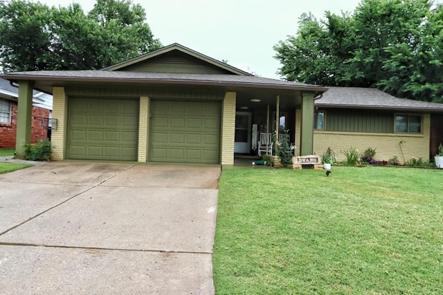 5704 N Warren Ave, Oklahoma City, OK 73112 - ranch-style home featuring an attached garage, brick siding, driveway, and a front yard