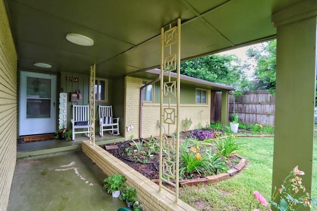 5704 N Warren Ave, Oklahoma City, OK 73112 - property entrance with a porch and brick siding