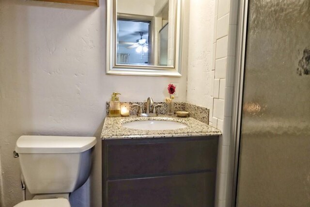 5704 N Warren Ave, Oklahoma City, OK 73112 - full bath with toilet, vanity, a stall shower, and a ceiling fan
