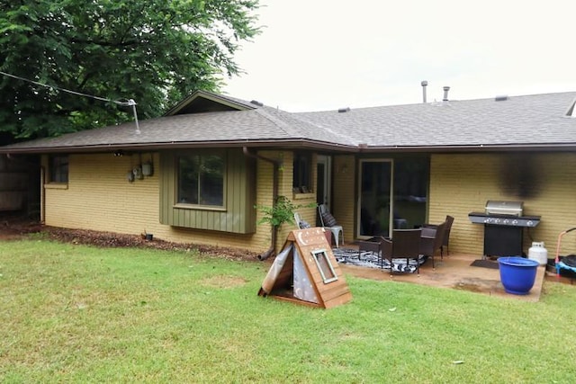 5704 N Warren Ave, Oklahoma City, OK 73112 - back of property featuring a shingled roof, brick siding, and a patio area