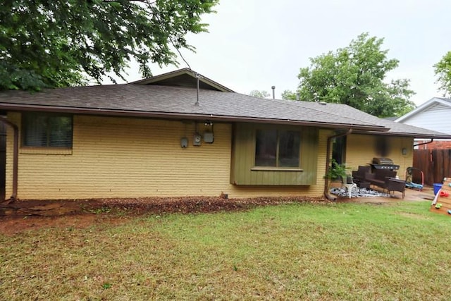 5704 N Warren Ave, Oklahoma City, OK 73112 - back of property with roof with shingles, brick siding, and a patio area