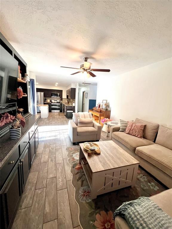 5704 N Warren Ave, Oklahoma City, OK 73112 - living area with a ceiling fan, hardwood / wood-style floors, and a textured ceiling