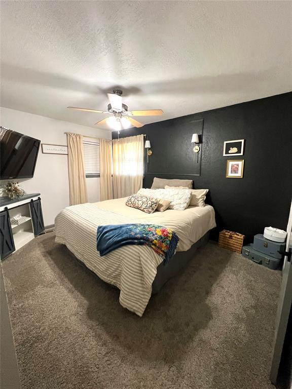 5704 N Warren Ave, Oklahoma City, OK 73112 - bedroom with carpet flooring, ceiling fan, and a textured ceiling
