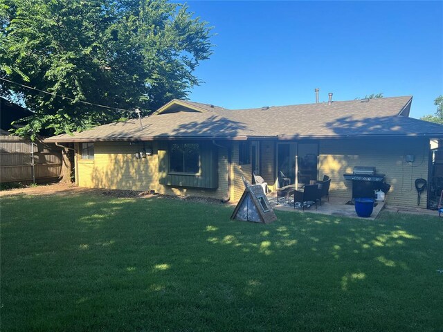 5704 N Warren Ave, Oklahoma City, OK 73112 - rear view of house featuring a patio area, roof with shingles, and brick siding
