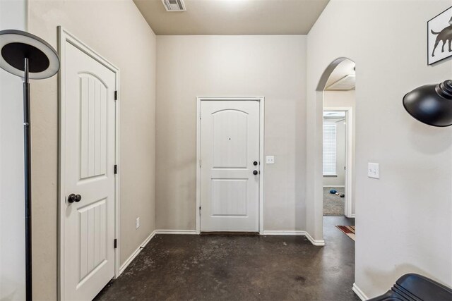 1012 SW 13th St, Moore, OK 73160 - foyer entrance featuring concrete floors, arched walkways, and baseboards