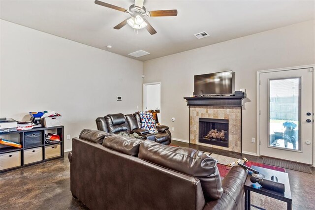 1012 SW 13th St, Moore, OK 73160 - living room with a ceiling fan, a tiled fireplace, baseboards, and finished concrete floors