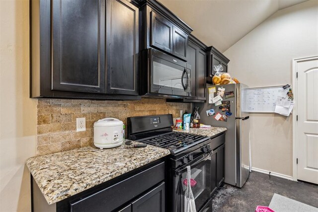 1012 SW 13th St, Moore, OK 73160 - kitchen featuring black appliances, vaulted ceiling, tasteful backsplash, light stone counters, and dark cabinets