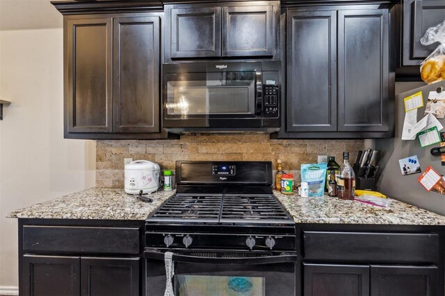 1012 SW 13th St, Moore, OK 73160 - kitchen with black appliances, tasteful backsplash, light stone countertops, and dark brown cabinetry