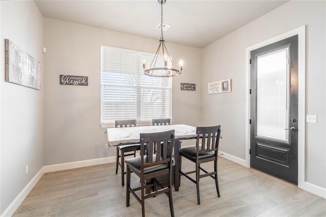 5808 Ledgestone Dr, Mustang, OK 73064 - dining room featuring a chandelier, baseboards, and light wood-style floors