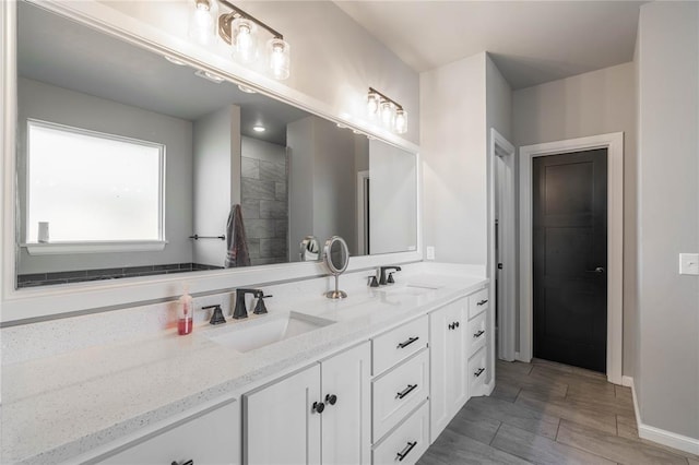 5808 Ledgestone Dr, Mustang, OK 73064 - bathroom featuring double vanity, baseboards, and wood finished floors