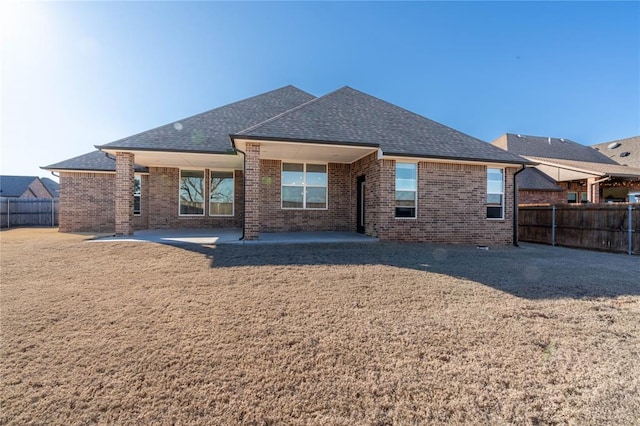 5808 Ledgestone Dr, Mustang, OK 73064 - rear view of house with brick siding, roof with shingles, and a patio area