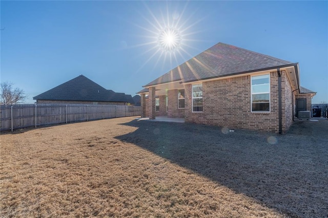 5808 Ledgestone Dr, Mustang, OK 73064 - back of property with brick siding, a patio area, and roof with shingles