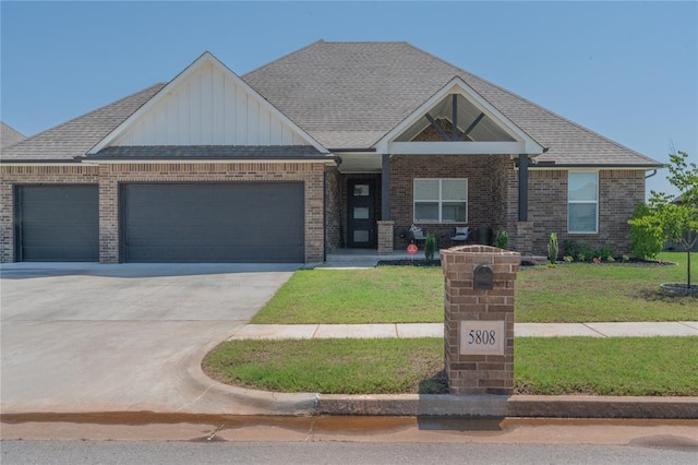 5808 Ledgestone Dr, Mustang, OK 73064 - craftsman-style house featuring a garage, board and batten siding, a front yard, and concrete driveway