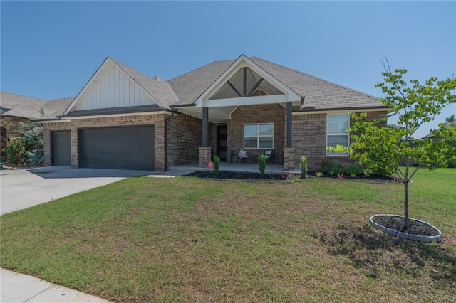5808 Ledgestone Dr, Mustang, OK 73064 - view of front of property with a garage, board and batten siding, covered porch, a front lawn, and brick siding