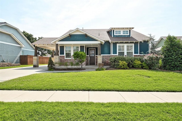 1508 Station St, Edmond, OK 73034 - craftsman inspired home featuring driveway, a carport, brick siding, and a shingled roof