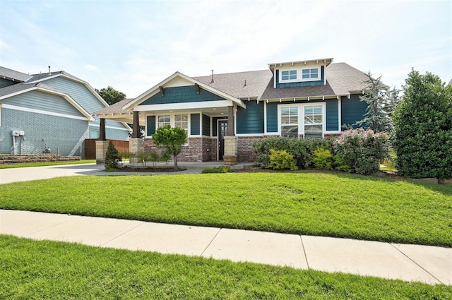 1508 Station St, Edmond, OK 73034 - craftsman-style house featuring a front yard, brick siding, roof with shingles, and concrete driveway