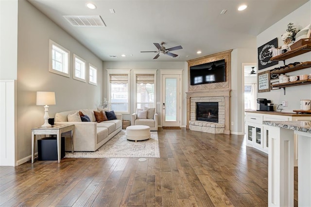 1508 Station St, Edmond, OK 73034 - living room with ceiling fan, a stone fireplace, dark wood-style floors, and recessed lighting