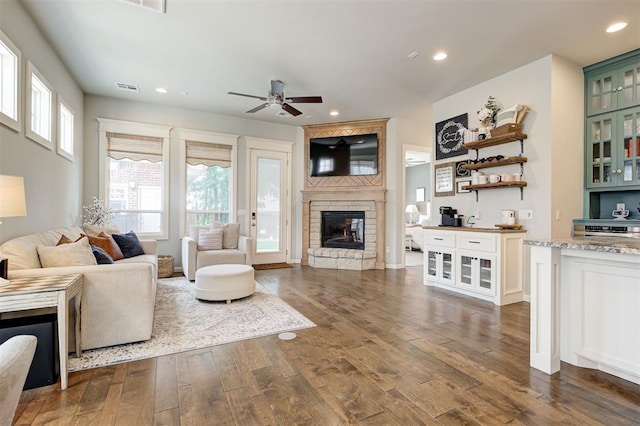 1508 Station St, Edmond, OK 73034 - living room featuring a fireplace, dark wood finished floors, ceiling fan, and recessed lighting