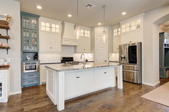 1508 Station St, Edmond, OK 73034 - kitchen with appliances with stainless steel finishes, custom exhaust hood, dark wood-style flooring, decorative backsplash, and recessed lighting