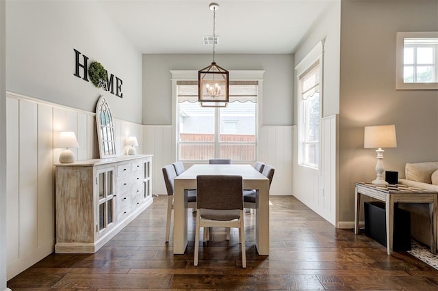 1508 Station St, Edmond, OK 73034 - dining area featuring a wainscoted wall, dark wood finished floors, a chandelier, and a decorative wall