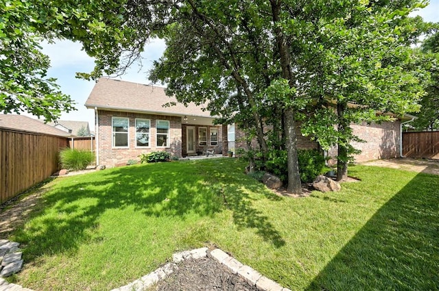 1508 Station St, Edmond, OK 73034 - back of property with brick siding and a fenced backyard