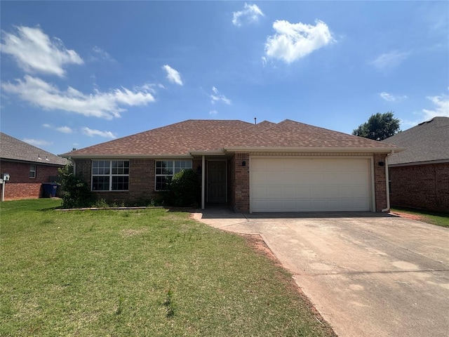 536 E Juniper Ln, Mustang, OK 73064 - single story home featuring driveway, a garage, a front lawn, and brick siding