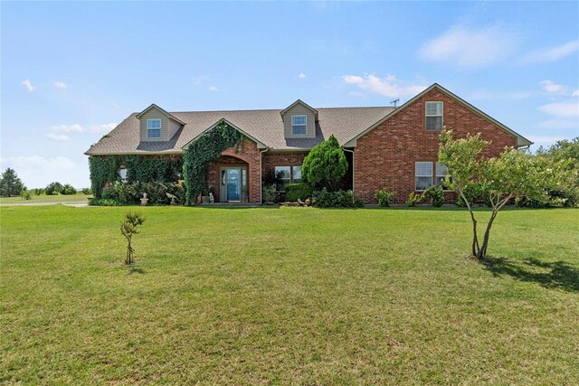 16350 SW 15th St, Yukon, OK 73099 - view of front of house featuring a front yard and brick siding