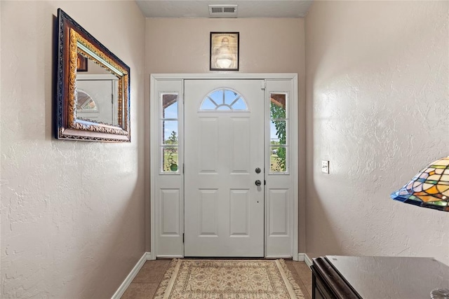 16350 SW 15th St, Yukon, OK 73099 - foyer entrance featuring baseboards, light tile patterned flooring, and a textured wall