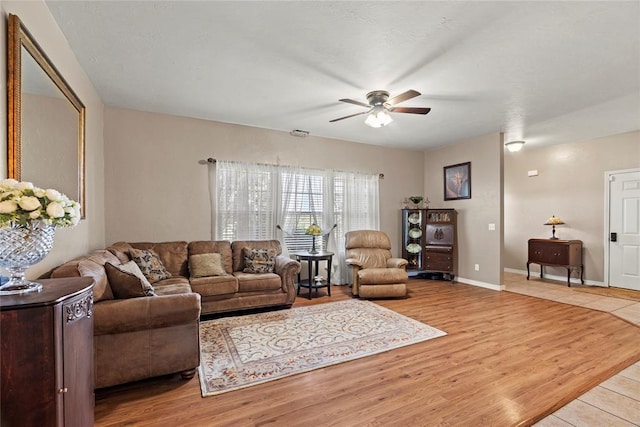16350 SW 15th St, Yukon, OK 73099 - living room featuring a ceiling fan, light wood finished floors, and baseboards
