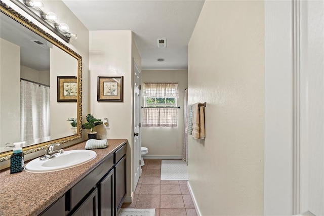16350 SW 15th St, Yukon, OK 73099 - full bath featuring toilet, vanity, tile patterned flooring, and baseboards