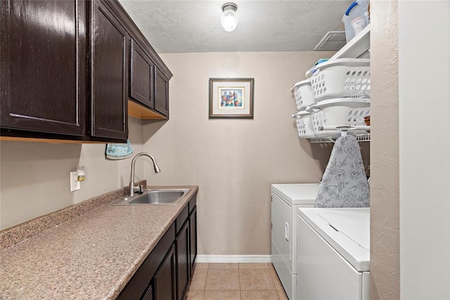 16350 SW 15th St, Yukon, OK 73099 - washroom with cabinet space, washer and clothes dryer, baseboards, and light tile patterned floors