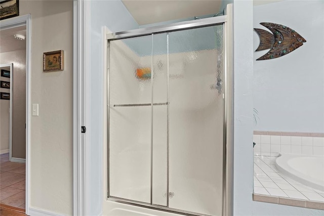 16350 SW 15th St, Yukon, OK 73099 - full bath featuring a shower stall, a garden tub, tile patterned flooring, and baseboards