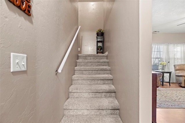 16350 SW 15th St, Yukon, OK 73099 - staircase featuring a textured wall and wood finished floors