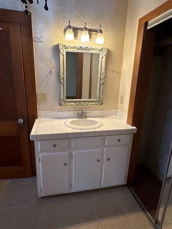 408 N Findlay St, Norman, OK 73071 - bathroom featuring vanity, a textured wall, and tile patterned floors