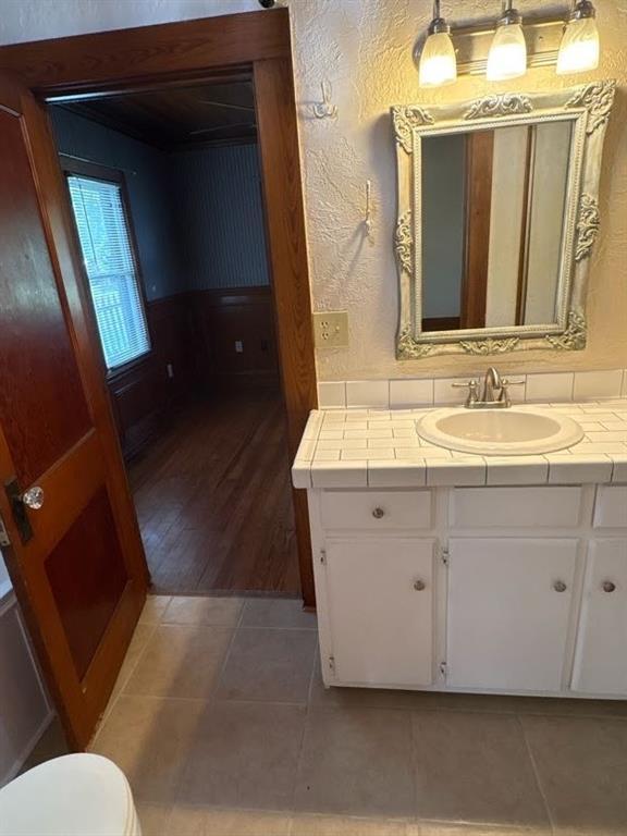 408 N Findlay St, Norman, OK 73071 - bathroom featuring vanity, a textured wall, and toilet