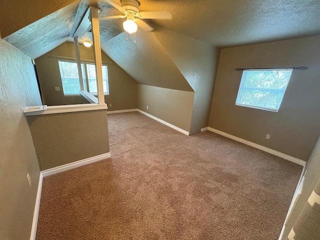 408 N Findlay St, Norman, OK 73071 - bonus room featuring a ceiling fan, a textured ceiling, carpet flooring, vaulted ceiling, and baseboards