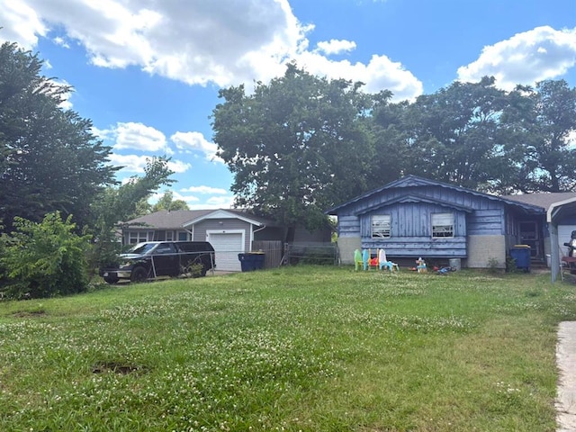 1013 S Anderson Rd, Choctaw, OK 73020 - view of green lawn featuring a garage