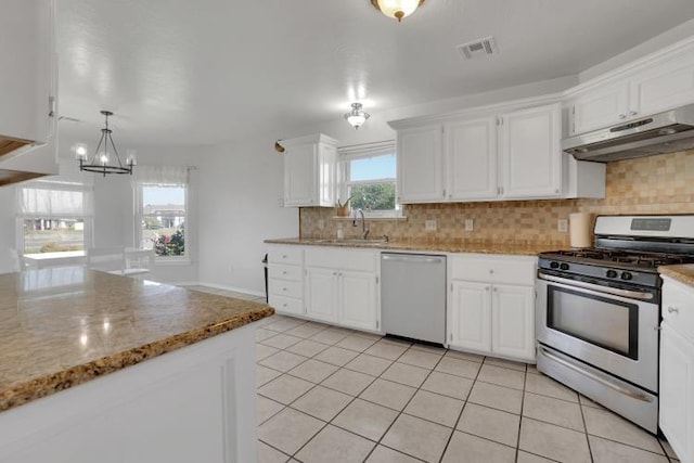 2 NW Havenshire Cir, Lawton, OK 73505 - kitchen featuring dishwashing machine, gas range, under cabinet range hood, a sink, and white cabinetry
