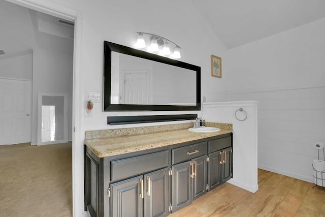 2 NW Havenshire Cir, Lawton, OK 73505 - bathroom with vaulted ceiling, vanity, and wood finished floors