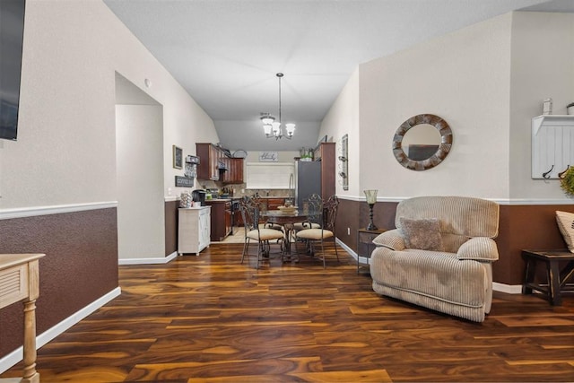 12329 SW 9th Ter, Yukon, OK 73099 - living area featuring dark wood-style flooring, a chandelier, lofted ceiling, and baseboards